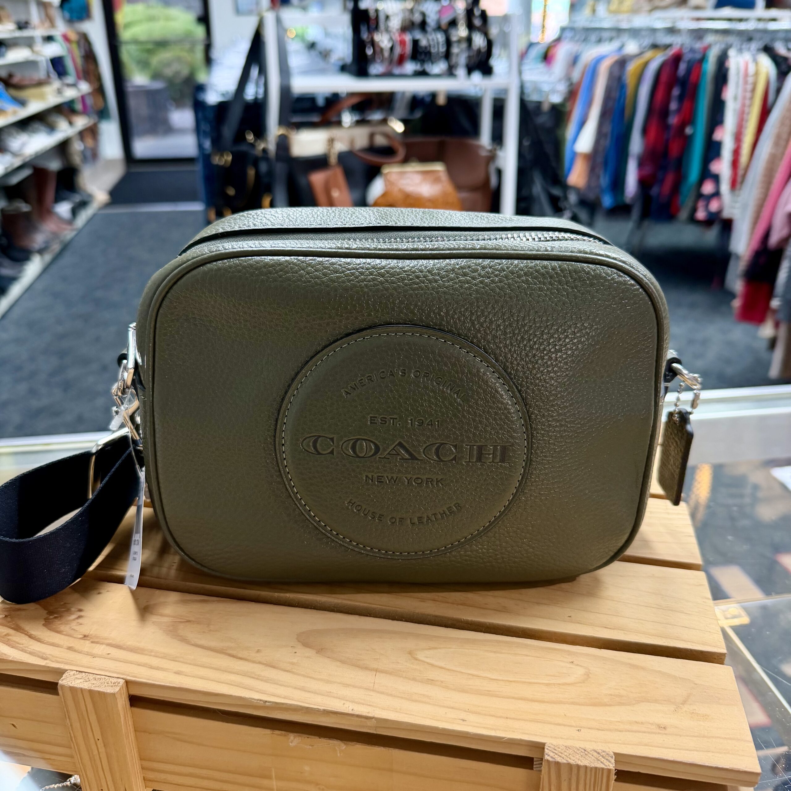 Authentic Coach Carter olive green leather crossbody bag in a women's fashion boutique.