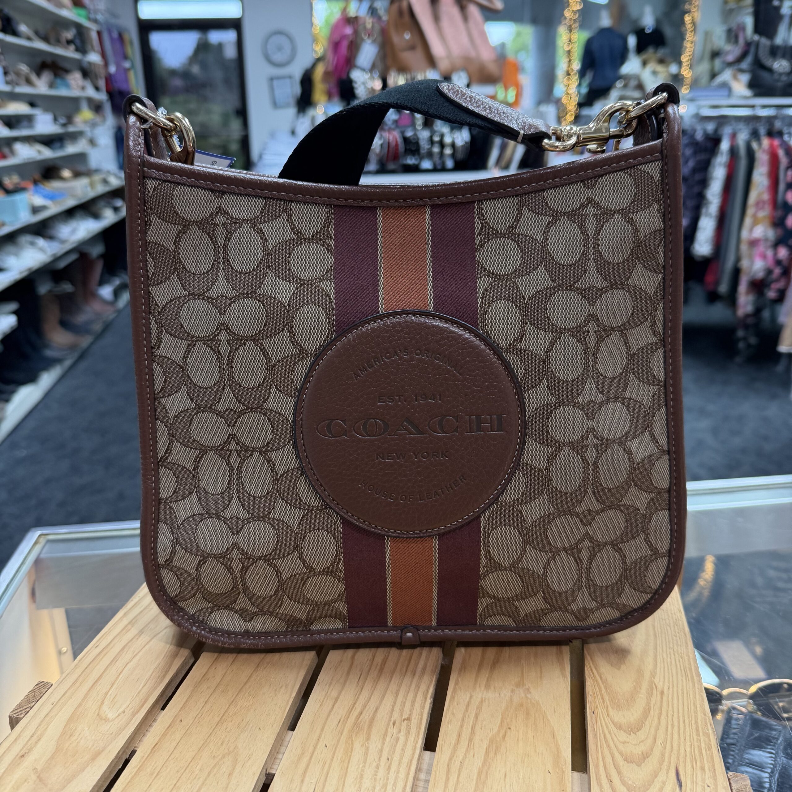 Authentic Coach Signature canvas crossbody bag with tan leather trim, varsity stripe detail, and embossed Coach leather patch.