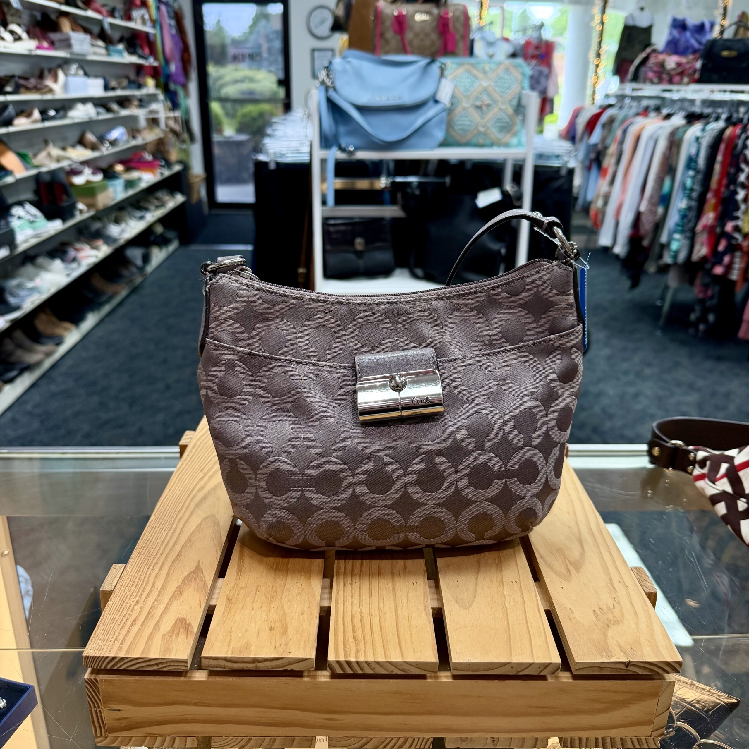 Authentic Coach Signature jacquard shoulder bag in beige-gray with leather trim, polished turn-lock closure, and adjustable shoulder strap.